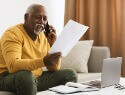 Man on the phone looking at papers